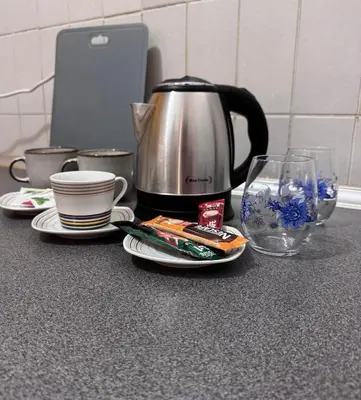 a counter with a coffee pot and plates and glasses at Apartments Damjan in Budva