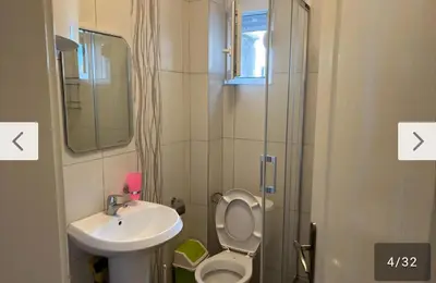 a bathroom with a sink and a toilet and a mirror at Apartmani Lucija Sutomore in Sutomore