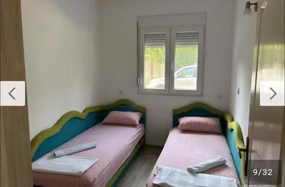 two beds in a room with two baseball bats at Apartmani Lucija Sutomore in Sutomore