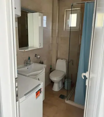 a bathroom with a toilet and a sink and a shower at The View Apartment in Budva