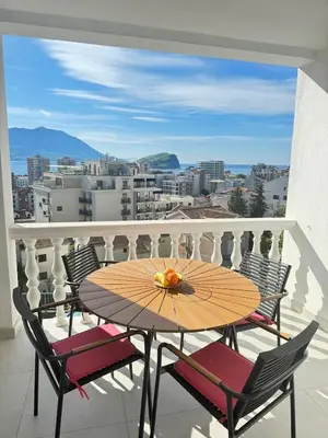 a table and chairs on a balcony with a view at The View Apartment in Budva