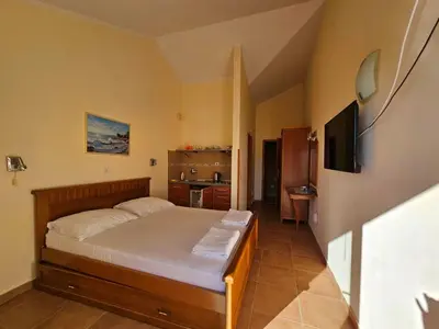 a bedroom with a bed and a television in it at Apartments Premier in Budva