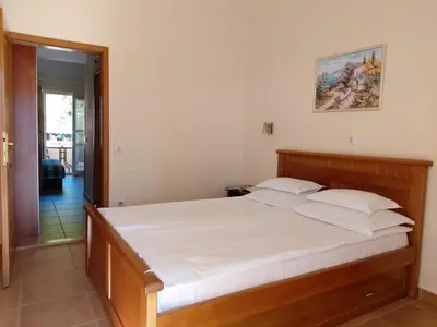 a bedroom with a large bed with white sheets at Apartments Premier in Budva