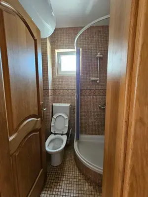 a bathroom with a toilet and a tub and a sink at Apartments Premier in Budva