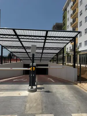 a building with awning over a parking lot at Apartment 43 with Garage in Podgorica