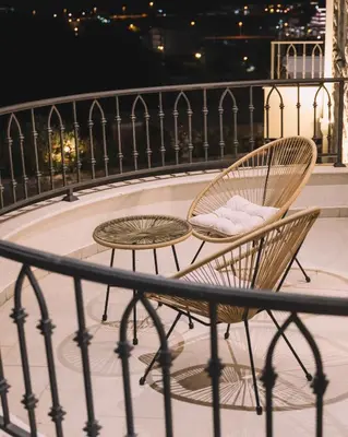 a couple of chairs and a table on a balcony at Azanti Residence in Ulcinj