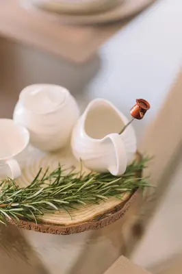 a table topped with white bowls and greens on a table at Azanti Residence in Ulcinj