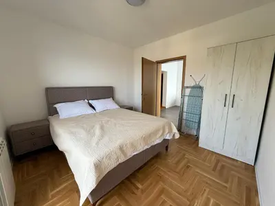 a bedroom with a bed and a wooden floor at Alice in Seoca