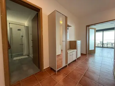 a bathroom with a walk in shower and a glass door at Alice in Seoca