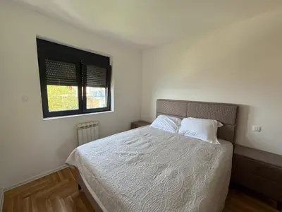 a bedroom with a bed with white sheets and a window at Alice in Seoca