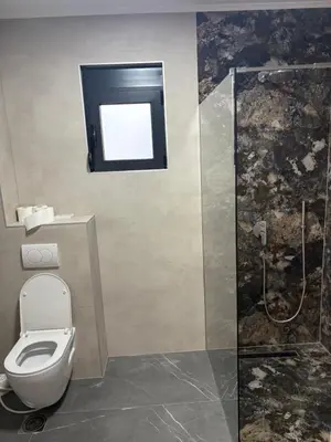 a bathroom with a toilet and a shower at Vila Enesa in Dobra Voda