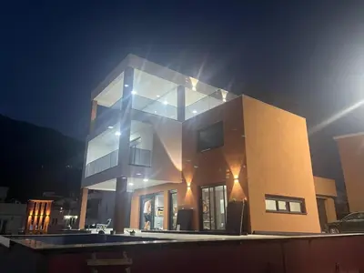 a large building with lights on it at night at Vila Enesa in Dobra Voda