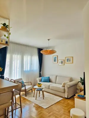 a living room with a couch and a table at Sea Colours Apartment Budva in Budva