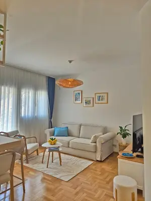a living room with a couch and a table at Sea Colours Apartment Budva in Budva