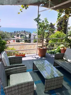 a patio with wicker chairs and a glass table at Jon in Ulcinj