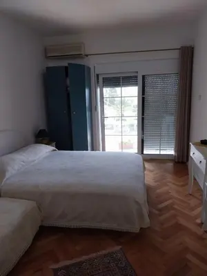 a bedroom with a large bed and a wooden floor at Jon in Ulcinj