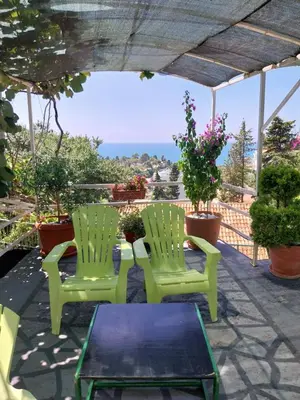 two green chairs and a table on a patio at Jon in Ulcinj