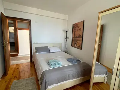 a bedroom with a bed and a mirror at Apartment Luna in Ulcinj