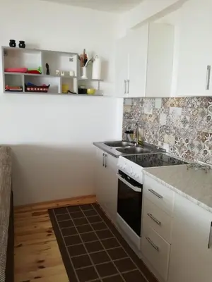 a white kitchen with a sink and a stove at Apartment Luna in Ulcinj