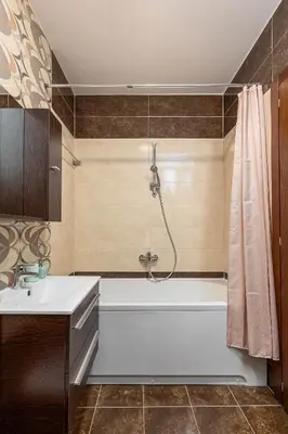 a bathroom with a white tub and a sink at Just 7 Min from the Beach Stylish 2BR in Becici