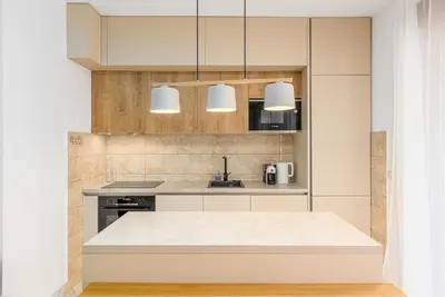 a kitchen with white cabinets and a sink at Just 7 Min from the Beach Stylish 2BR in Becici