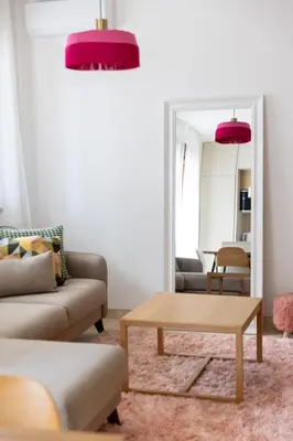 a living room with a couch and a table at Just 7 Min from the Beach Stylish 2BR in Becici