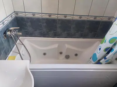 a bathroom with a white tub with a shower at Goran in Budva