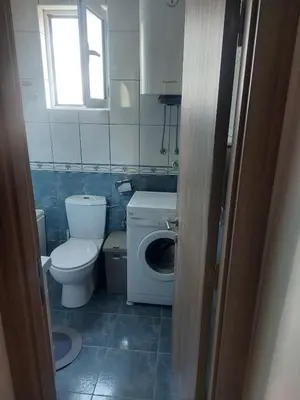 a bathroom with a toilet and a washing machine at Goran in Budva