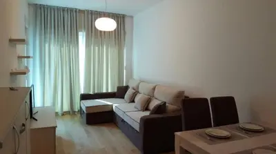 a living room with a couch and a table at Apartment WaveSea in Becici