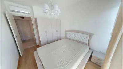 a small bedroom with a white bed in a room at Apartment WaveSea in Becici
