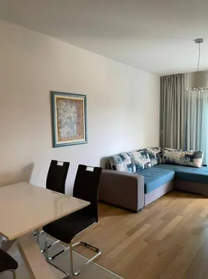 a living room with a bed and a table at Apartment WaveSea in Becici