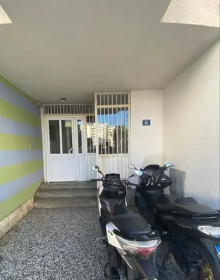 a motorcycle parked in front of a door at Kosta in Bar