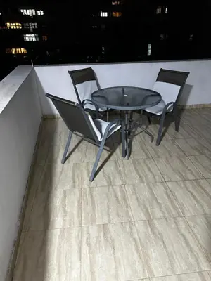 a table and two chairs on a roof at Sara s Apartments in Ulcinj