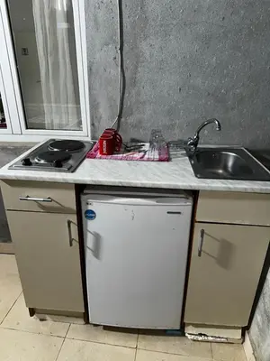 a kitchen counter top with a sink and a sink at Sara s Apartments in Ulcinj
