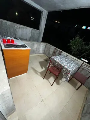 a patio with a counter and a table and chairs at Sara s Apartments in Ulcinj