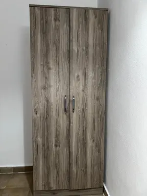a wooden cabinet in the corner of a room at Sara s Apartments in Ulcinj