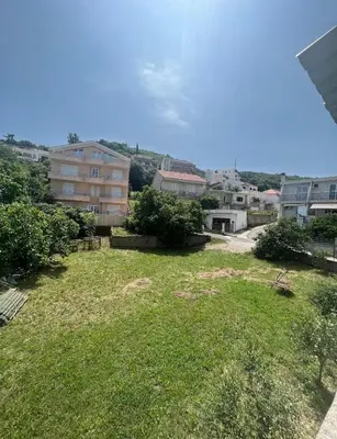 a view of a yard with grass and buildings at Sara s Apartments in Ulcinj