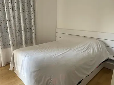 a white bed in a white bedroom with a window at Lux apartment Ruzmarin in Becici