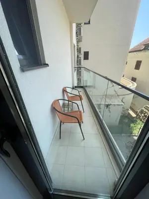a balcony with two chairs and a glass railing at Lux apartment Ruzmarin in Becici