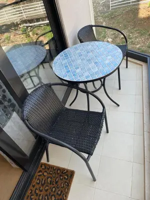 two tables and chairs sitting on a balcony at Lux apartment Ruzmarin in Becici