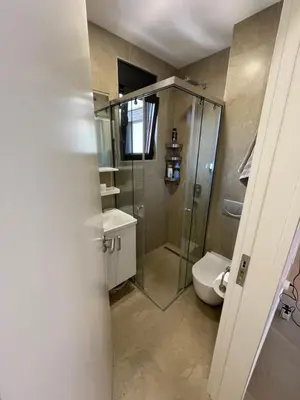 a bathroom with a glass shower and a toilet at Lux apartment Ruzmarin in Becici
