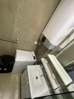 a bathroom with a white sink and a toilet at Lux apartment Ruzmarin in Becici