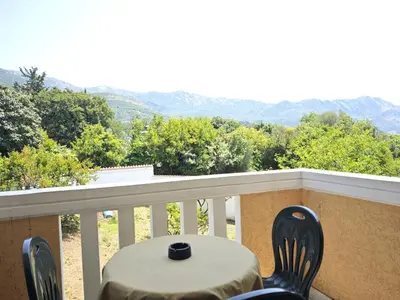 a table and chairs on a balcony with a view at Guest House Anika in Becici