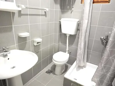 a bathroom with a toilet and a sink at Guest House Anika in Becici