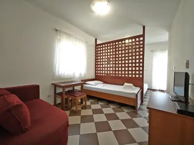 a living room with a couch and a tv at Guest House Anika in Becici