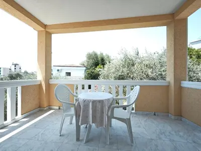 a balcony with a table and chairs on it at Guest House Anika in Becici