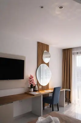 a living room with a desk and a mirror at Hotel Adler in Ulcinj