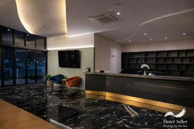 a lobby with a reception desk in a building at Hotel Adler in Ulcinj