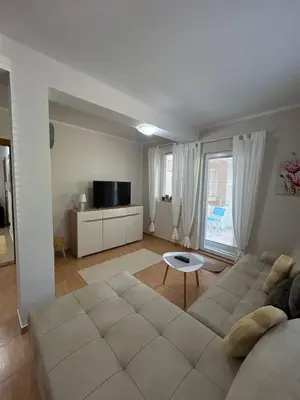 a living room with a couch and a table at Apartment Elena in Prijevor