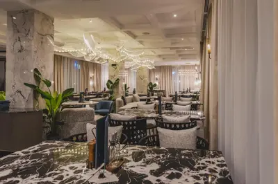 a restaurant with tables and chairs in a room at Luminoso Boutique Hotel in Budva